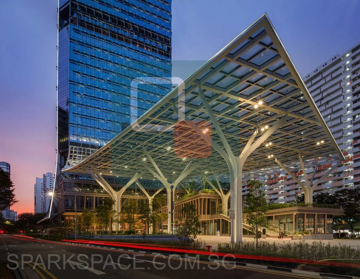 The glass canopy and public plaza at Keppel South Central lit at dusk
