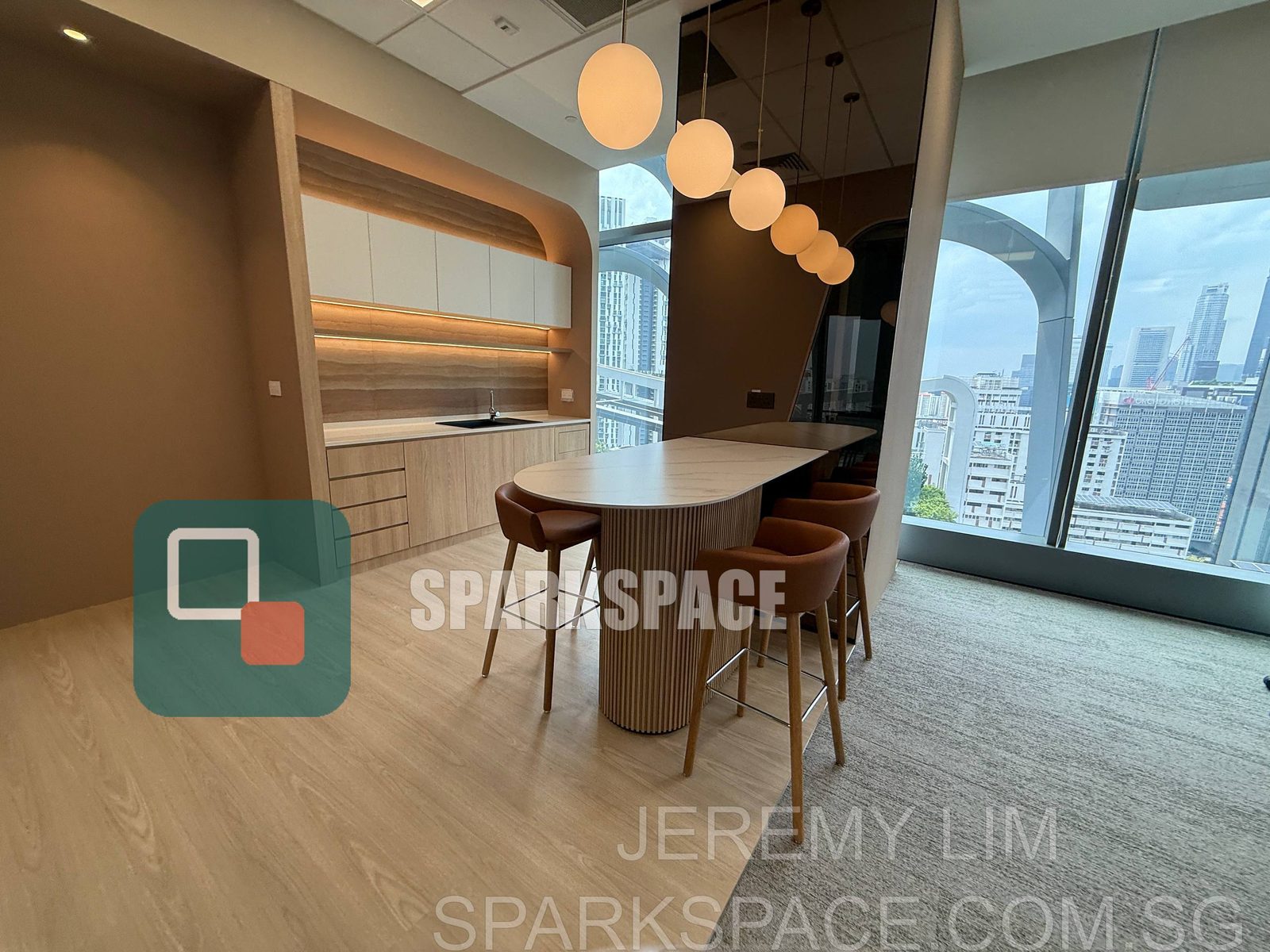 High-table breakout area with pendant lights in a Keppel South Central fitted office