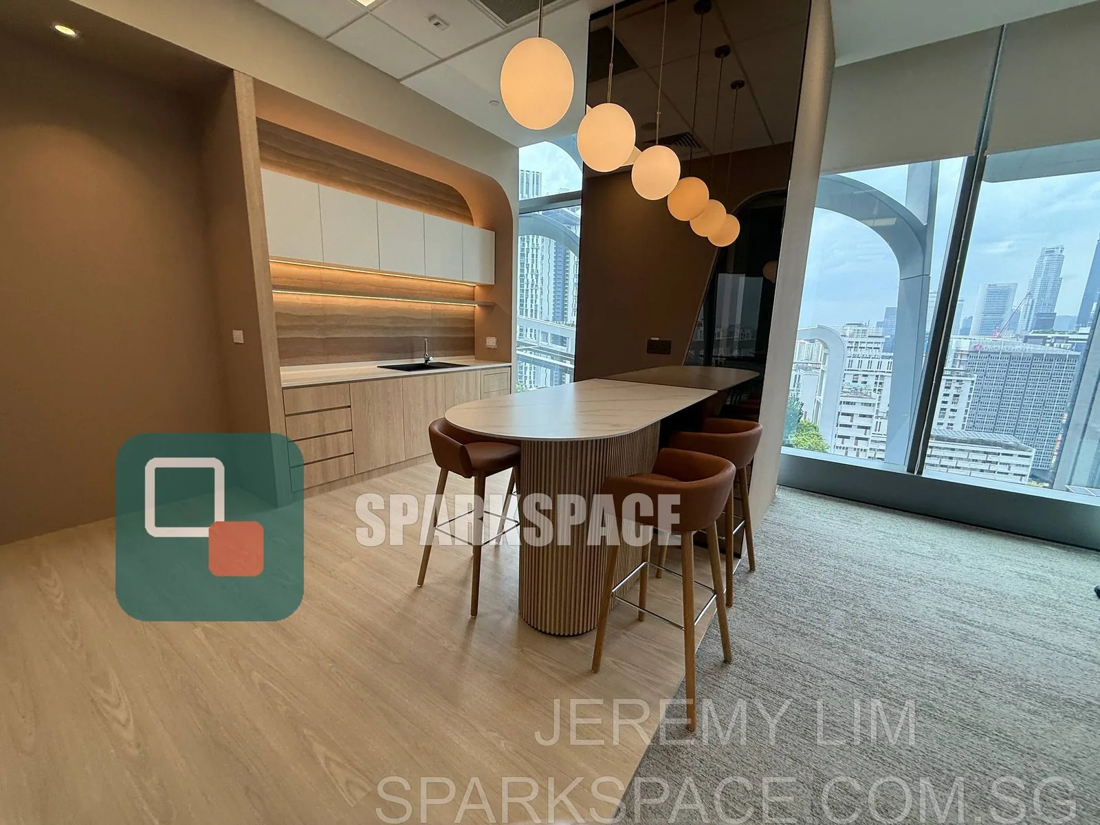 High-table breakout area with pendant lights in a Keppel South Central fitted office