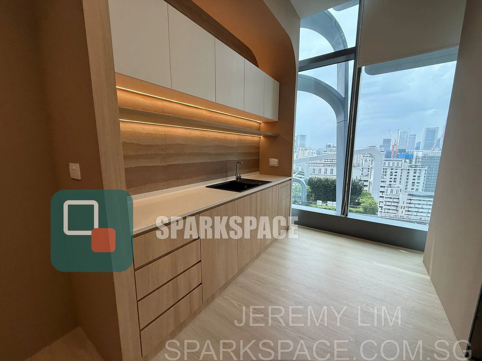 Fitted kitchenette with stone counter and city view at Keppel South Central