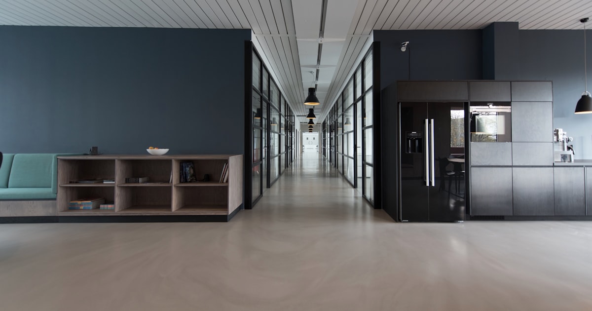 Modern office interior in Singapore with open lounge seating, natural light and planting